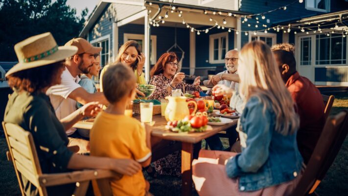 Parents,,Children,And,Friends,Gathered,At,A,Barbecue,Dinner,Table Genesis II S355 LP Stainless Steel, Cover and iGrill 3